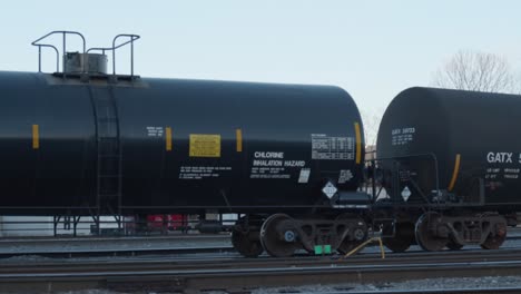 Large-black-fuel-tank-cars-moving-slowly-from-left-to-right