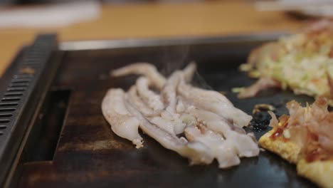 Squid-being-grilled-with-Yakisoba,-close-up-shot