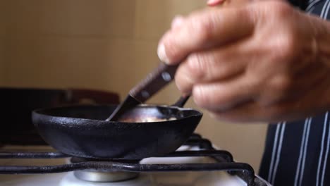 Homemade-caramel-sauce-cooking-on-rustic-hot-stove,-closeup
