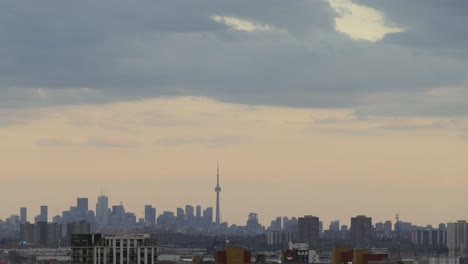 Toronto-skyline-and-CN-Tower-timelapse-on-cloudy-day,-distance-shot