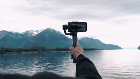 A-videographer-taking-a-video-on-a-gimbal-in-the-French-mountains