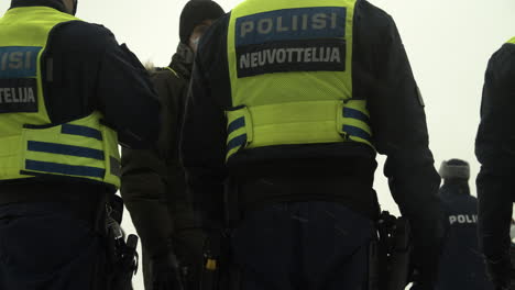Medium-wide-shot-of-police-on-duty-in-Helsinki-wearing-high-visibility-vests,-during-the-Helsinki-demonstrations