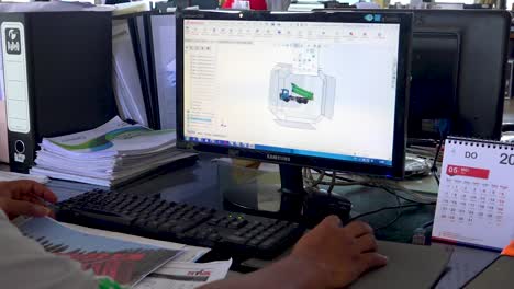 Engineer-in-office-creates-dump-truck-design-with-professional-computer-program