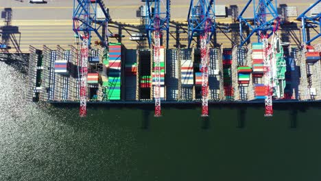 Container-ship-in-import-export-and-business-logistic,-By-crane,-Trade-Port,-Shipping-cargo-to-harbor,-Aerial-view-from-drone,-International-transportation,-Business-logistics-concept