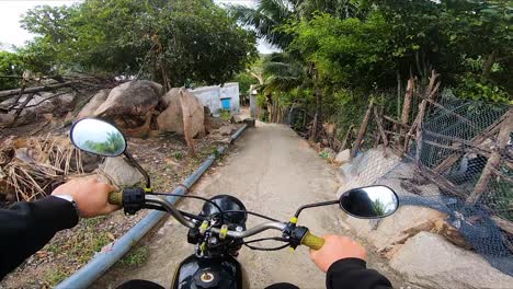 Pov-shot-of-male-person-driving-motorbike-on-narrow-trail-in-local-housing-area-of-Vietnam