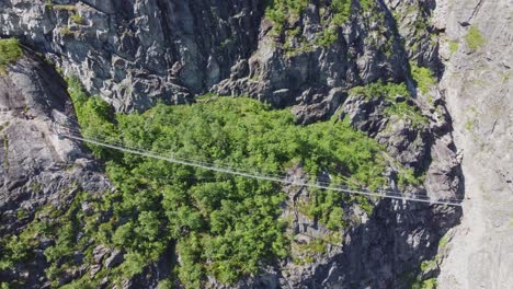 Crazy-spectacular-bridge-over-gorge-at-Via-Ferrata-route-to-mountain-Hoven-in-Loen-Norway---Aerial