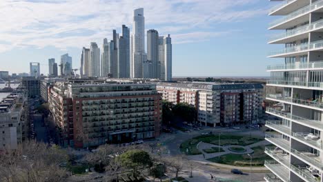 Aerial-backwards-shot-showing-residential-area-and-gigantic-skyline-of-Buenos-Aires-in-background