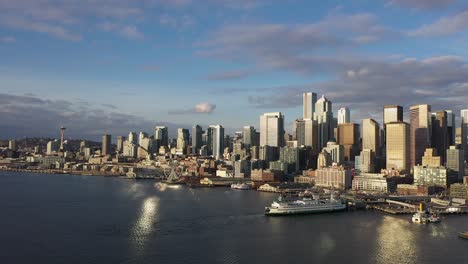 Drone-shot-of-Seattle's-skyline-from-the-water-at-sunset