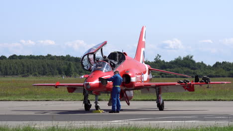 Mechanics-checking-Red-Arrows-aircraft-on-airstrip-before-take-off