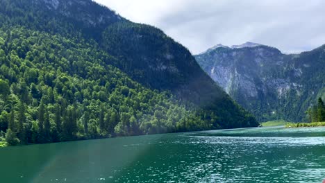 Lago-Idílico-En-Alemania-Rodeado-De-Montañas-Verdes-Y-Rayos-De-Sol-Y-Nubes---Destello-De-Lente-En-La-Cámara