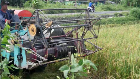 Yogyakarta,-Indonesia---Dec-11,-2021:Combine-harvester-machine-with-rice-paddy-field