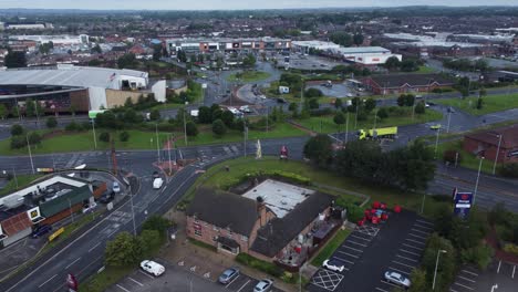 Aerial-view-above-busy-British-town-shopping-retail-car-park-store-traffic-shops