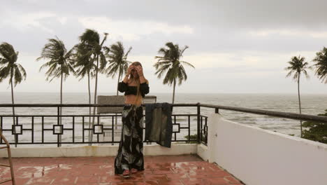 Long-haired-blonde-Russian-model-posing-in-front-of-the-camera-while-on-a-rooftop-along-the-ocean-in-Vietnam