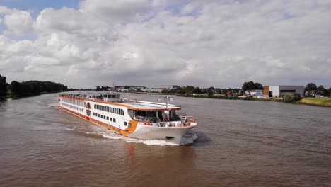 Aerial-Across-Forward-Bow-Of-MS-Vistastar-River-Cruise-Ship-On-River-Noord