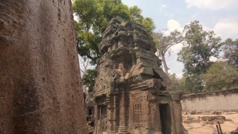 Group-of-tourists-admiring-the-stone-carved-walls-of-Angkor-Wat