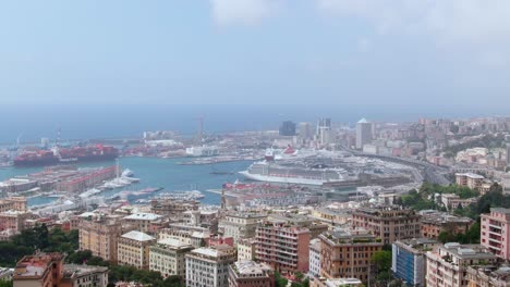 Massive-cruise-and-industrial-vessel-in-port-of-Genoa-with-cityscape-view,-aerial