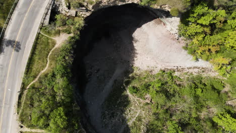 Aerial-circle-top-down-shot-of-famous-Devil's-Punch-Bowl-in-Canadian-Ontario-during-summer-day