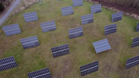 View-from-a-drone-on-rotating-solar-panels-placed-on-the-grass-in-autumn-in-the-Czech-Republic