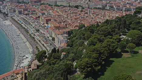 Nice-France-Aerial-v18-birds-eye-view-drone-fly-around-castle-hill-capturing-rauba-capeu-memorial,-scenic-artificial-waterfall-and-hilltop-historic-jewish-and-catholic-cemetery---July-2021