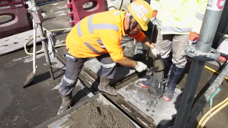 Male-Worker-Filling-And-Tamping-Concrete-Sample-In-An-Abrams-Cone