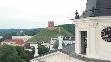 AERIAL:-Flying-Very-Close-To-Vilnius-Bell-Tower-on-Summer-Evening-with-Cross-on-Cathedral-Visible-in-Background