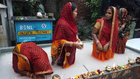 Close-up-shot-of-four-women's-standing-inside-the-water-and-doing-chatt-puja-rituals-in-Kolkata