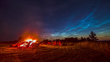 Bonfire-timelapse-during-camp-night-with-blue-fire-sky-and-unrecognizable-people