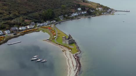 Aerial-view-of-Lochranza-Castle-on-the-Isle-of-Arran-on-an-overcast-day,-Scotland