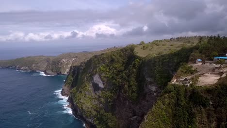 Smooth-aerial-view-flight-panorama-curve-flight-drone-shot-dramatic-clouds-Kelingking-Beach-at-Nusa-Penida-in-Bali-Indonesia-is-like-Jurassic-Park-Cinematic-nature-cliff-view-above-by-Philipp-Marnitz