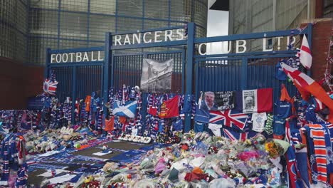 Wide-shot-of-tributes-in-memory-of-former-Rangers-manager,-Walter-Smith-outside-Ibrox-Stadium