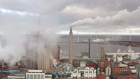 AERIAL-shot-of-a-manufacturing-plant-emitting-huge-amounts-of-smoke