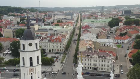 AERIAL:-Revealing-of-Vilnius-Cathedral-and-Gediminas-Avenue-on-a-Summer-Evening-with-People-Walking-in-Streets