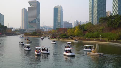 Songdo-Central-Park-in-Incheon-on-sunset---people-travel-on-boats-wearing-protective-masks-during-coronavirus-covid-19