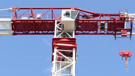 Fire-workers-climbing-down-from-a-modern-giant-crane,-clear-blue-sky-background