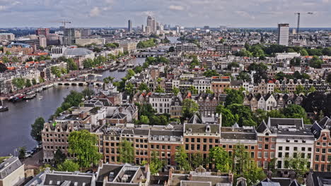 Amsterdam-Netherlands-Aerial-v43-drone-fly-along-amstel-river-across-grachtengordel-and-de-weteringschans-neighborhoods-capturing-downtown-cityscape-with-historic-dutch-townhouses---August-2021
