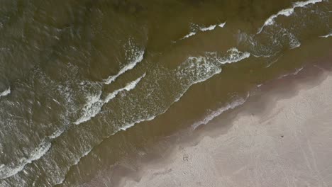 Topdown-Of-Foamy-Waves-Rolling-Into-Sandy-Coastline-Of-Baltic-Sea