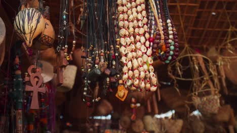 Egyptian-Bazaar-souvenir-shop,-close-up-of-beads-and-necklaces-moving-in-the-wind