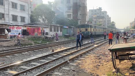 Local-train-passing-through-a-crowded-area-with-encroachment-on-both-side-by-local-people-of-Bangladesh