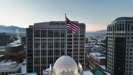 Beautiful-Aerial-Shot-Showing-American-Flag-Waving-in-Downtown-Salt-Lake-City-Utah---Orbit-Movement