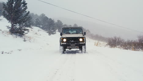 Land-Rover-Defender-D90-Backcountry-Off-Roading-On-Snowy-Road-During-Blizzard-Snowfall