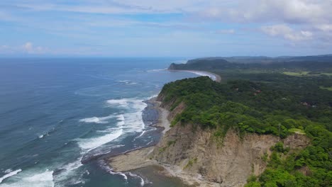Aerial-view-moving-forward-shot,-Scenic-view-of-the-colombian-coastline,-bright-blue-sky-in-the-background