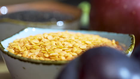 Close-up-of-a-ceramic-bowl-of-yellow-legume-beans-on-a-kitchen-table