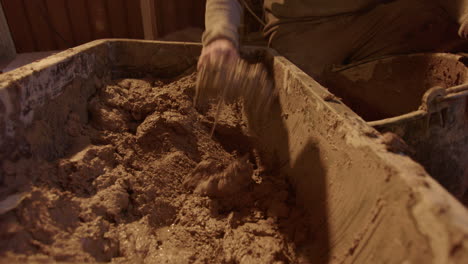 The-clay-mix-being-scooped-out-and-into-the-plasterers-bucket