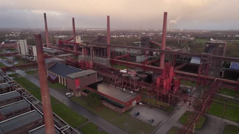 Zeche-Zollverein-coking-plant,-wet-cloudy-morning,-warm-light,-drone-shot
