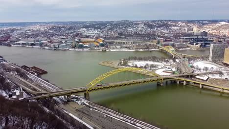 Aerial-View-of-Fort-Pitt-Bridge-with-Point-state-park,-three-rivers-and-heinz-field-in-the-background