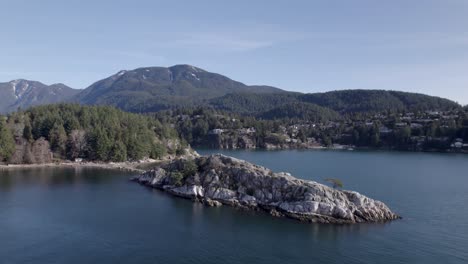 Aerial-panoramic-landscape-view-of-Whytecliff-Park,-West-Vancouver,-Canada,-with-white-rocks-in-calm-ocean-water