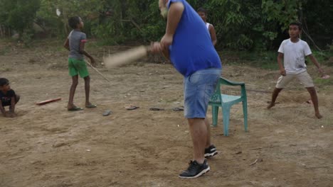 Man-playing-gudu-with-local-children,-Weligama,-Sri-Lanka
