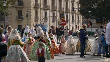 A-group-of-young-kids-in-traditional-Spanish-dresses-carry-flowers-during-the-Fallas-festival-in-Valencia