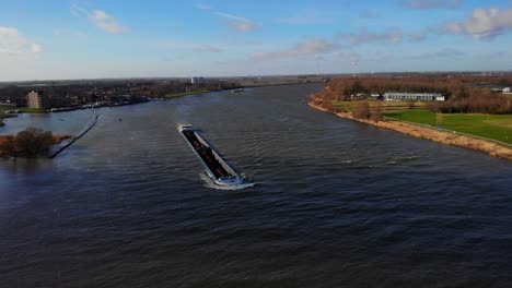 Aerial-Over-Oude-Maas-With-Sjouwer-Cargo-Ship-Navigating-Along-Through-Zwijndrecht