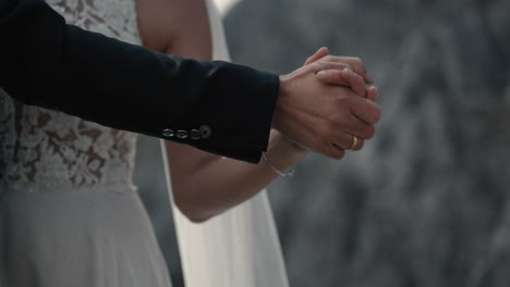 Bride-and-grooms-hands-holding-gentle-while-dancing-slowly---slowmotion